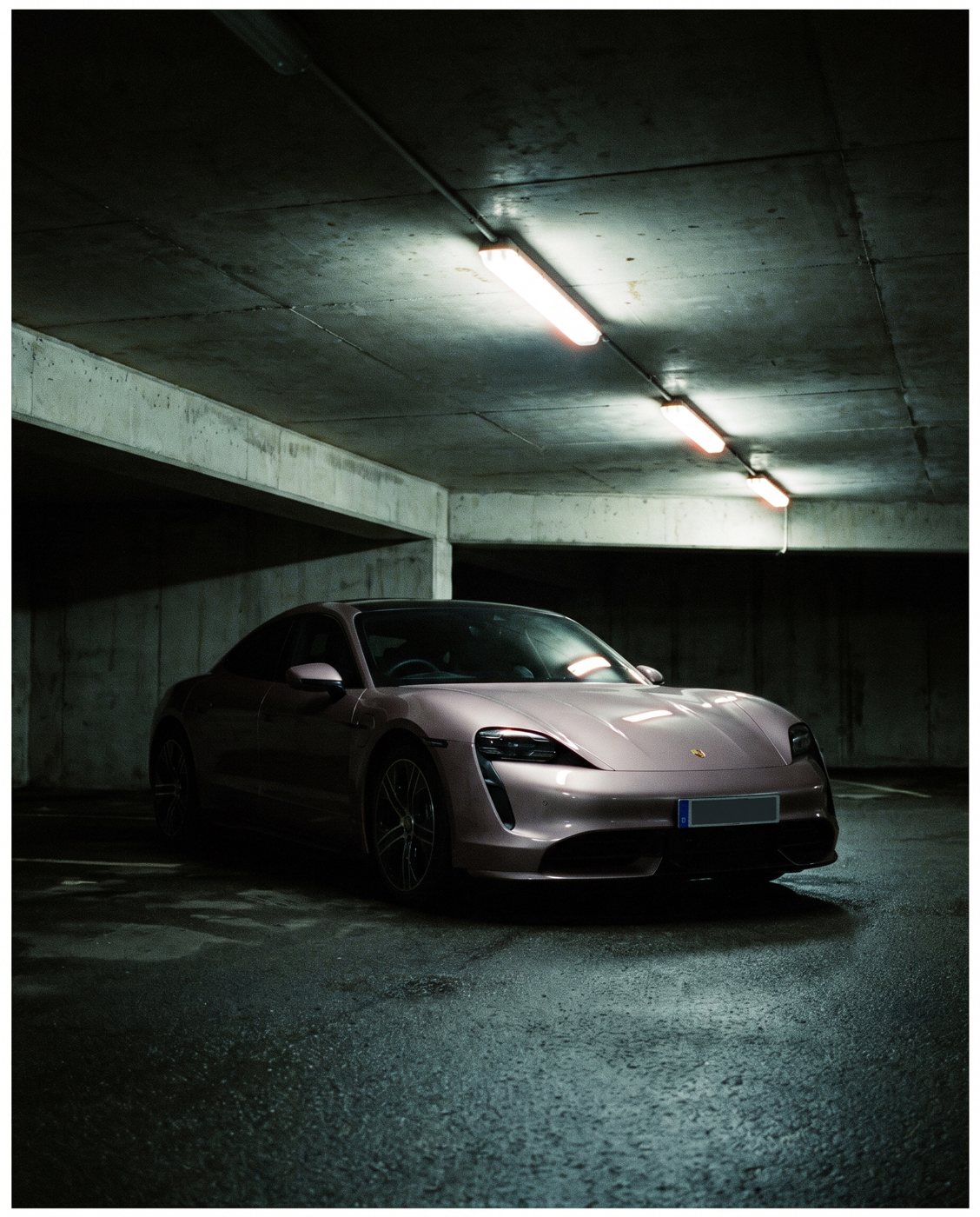 Electric sedan in a concrete parking garage