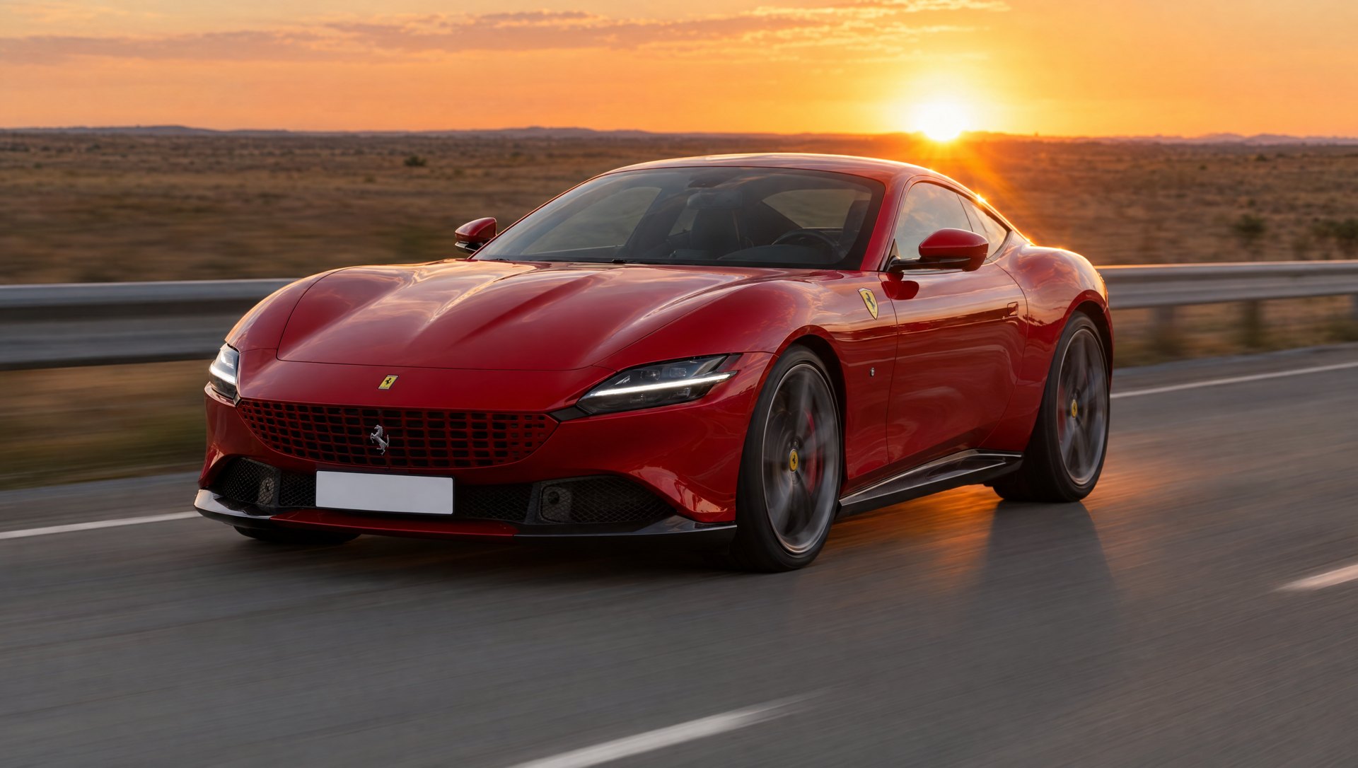 Red coupe on an open highway at sunset